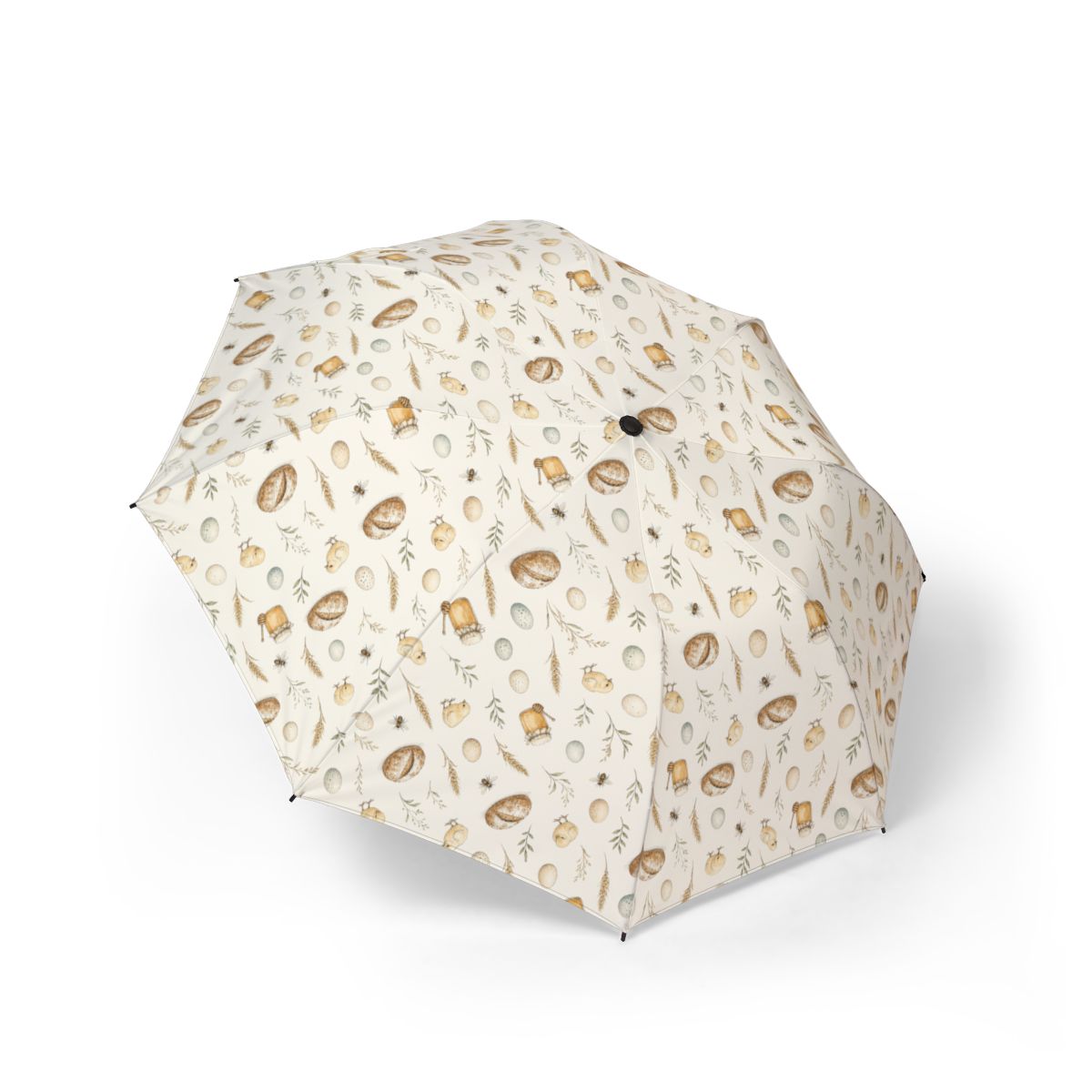 Open folding umbrella with bread, honey, eggs and leafy sprigs